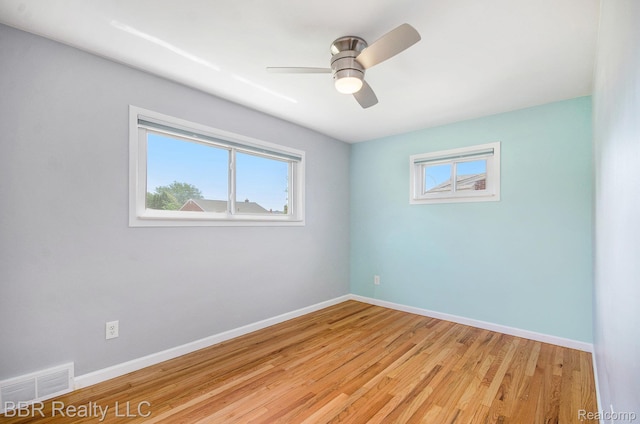 2890 Maxwell St, Trenton, MI 48183 - empty room featuring healthy amount of natural light, light wood-style flooring, and ceiling fan