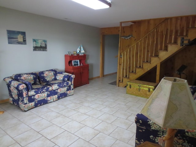 6325 Big Bay Rd, Bear Lake, MI 49614 - living room with stairs, light tile patterned floors, and wooden walls