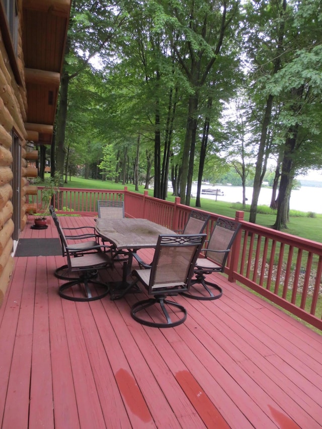 6325 Big Bay Rd, Bear Lake, MI 49614 - wooden deck with outdoor dining area, a water view, and view of scattered trees
