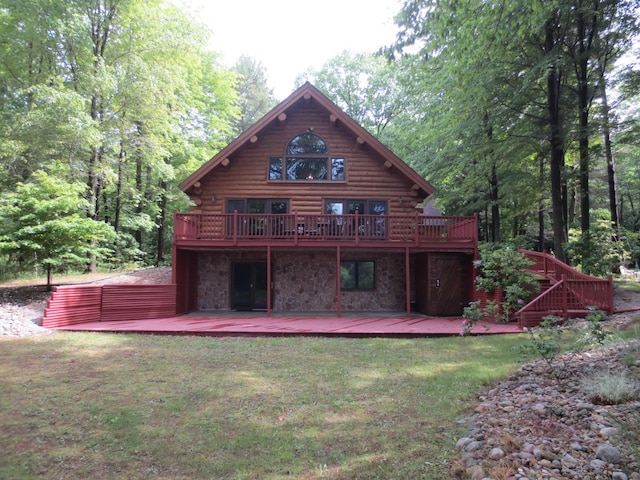 6325 Big Bay Rd, Bear Lake, MI 49614 - back of house featuring log siding, a wooden deck, and a lawn
