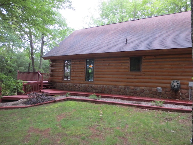 6325 Big Bay Rd, Bear Lake, MI 49614 - rear view of house featuring roof with shingles, a wooden deck, and log exterior