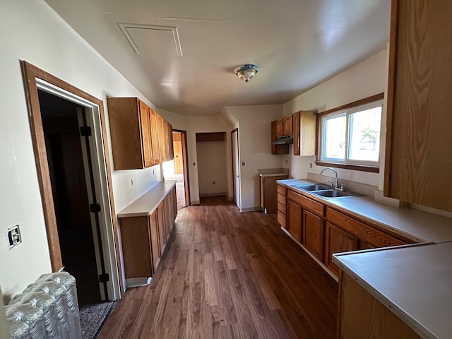 611 Steward Ave, Jackson, MI 49202 - kitchen with dark wood-style floors, brown cabinetry, and light countertops