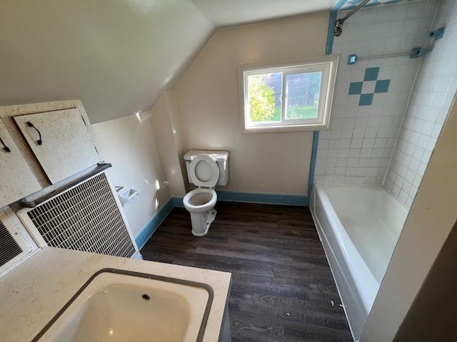 611 Steward Ave, Jackson, MI 49202 - bathroom with wood finished floors, vaulted ceiling, and  shower combination