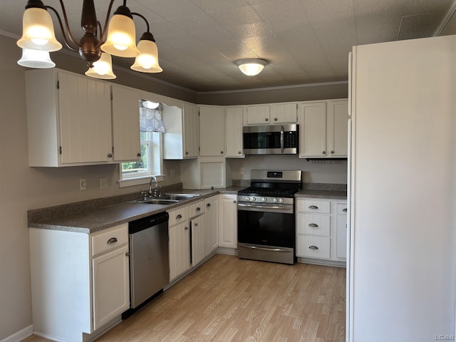 6143 Shepherd Rd, Adrian, MI 49221 - kitchen featuring appliances with stainless steel finishes, light wood-type flooring, white cabinetry, and dark countertops