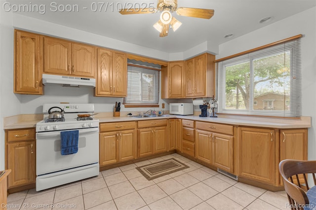 25416 Yale St S, Dearborn Heights, MI 48125 - kitchen with white appliances, under cabinet range hood, light tile patterned flooring, and light countertops