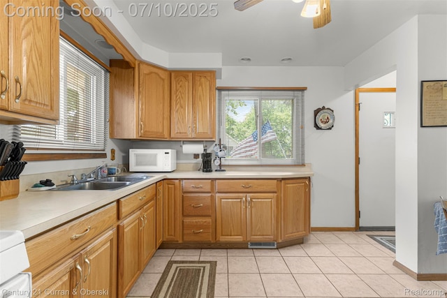 25416 Yale St S, Dearborn Heights, MI 48125 - kitchen with white microwave, light countertops, light tile patterned floors, and a ceiling fan