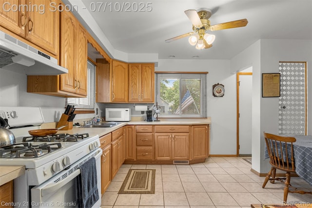 25416 Yale St S, Dearborn Heights, MI 48125 - kitchen with white appliances, range hood, healthy amount of natural light, and light countertops