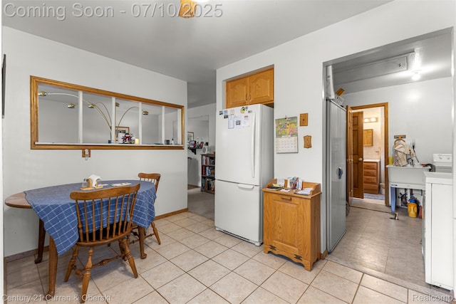 25416 Yale St S, Dearborn Heights, MI 48125 - kitchen with freestanding refrigerator, light tile patterned floors, and brown cabinetry