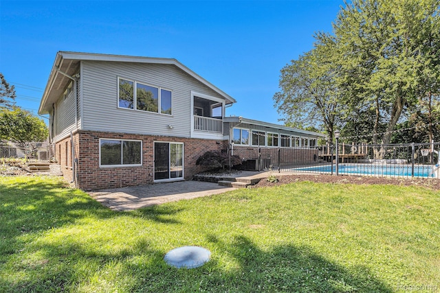 2145 Helmsford Dr, Wolverine Lake, MI 48390 - back of property featuring brick siding, a patio area, and a balcony