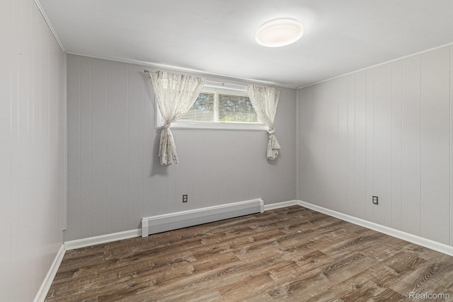 2145 Helmsford Dr, Wolverine Lake, MI 48390 - unfurnished room featuring a baseboard heating unit, wood finished floors, and crown molding
