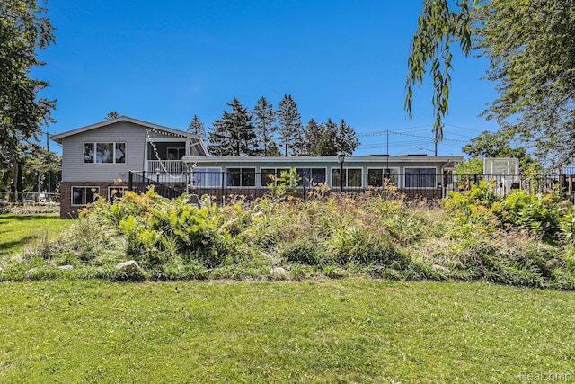 2145 Helmsford Dr, Wolverine Lake, MI 48390 - back of property with brick siding and a wooden deck
