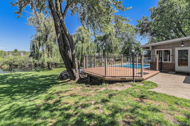 2145 Helmsford Dr, Wolverine Lake, MI 48390 - view of green lawn with a deck