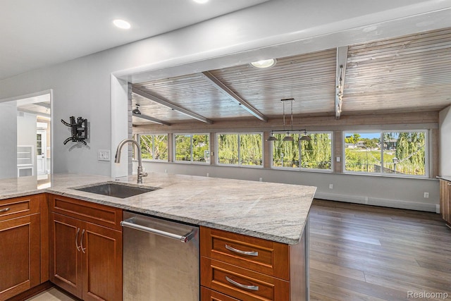 2145 Helmsford Dr, Wolverine Lake, MI 48390 - kitchen with stainless steel dishwasher, plenty of natural light, light stone counters, wood finished floors, and beamed ceiling