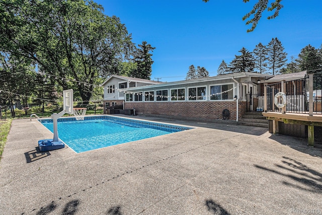 2145 Helmsford Dr, Wolverine Lake, MI 48390 - swimming pool featuring a wooden deck and a patio area
