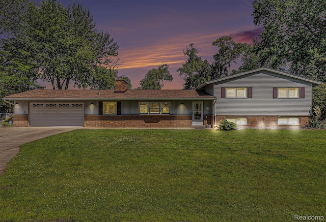2145 Helmsford Dr, Wolverine Lake, MI 48390 - tri-level home with a chimney, a garage, brick siding, and a front yard