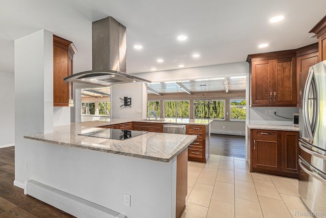2145 Helmsford Dr, Wolverine Lake, MI 48390 - kitchen with island exhaust hood, a peninsula, stainless steel appliances, light stone counters, and recessed lighting