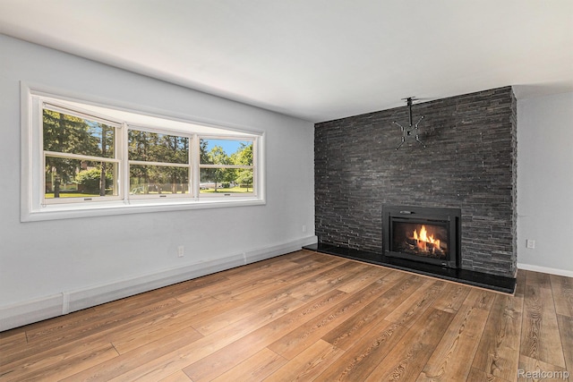 2145 Helmsford Dr, Wolverine Lake, MI 48390 - unfurnished living room featuring a stone fireplace and wood finished floors