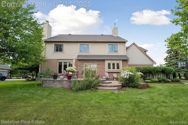 47451 Wallingford Ct, Canton, MI 48188 - back of property with a lawn, a chimney, and brick siding