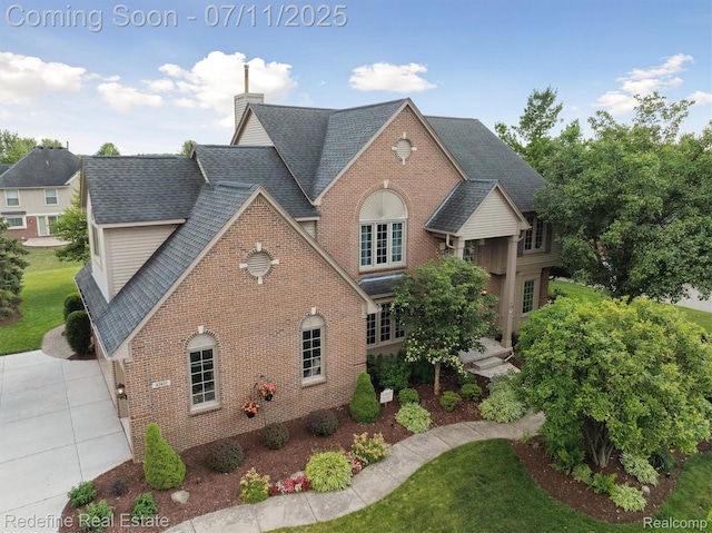 47451 Wallingford Ct, Canton, MI 48188 - view of front of home with brick siding, a chimney, and roof with shingles