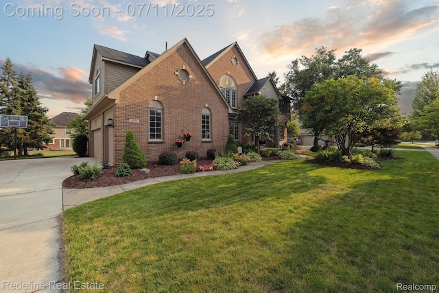 47451 Wallingford Ct, Canton, MI 48188 - property exterior at dusk featuring brick siding, driveway, a yard, and an attached garage