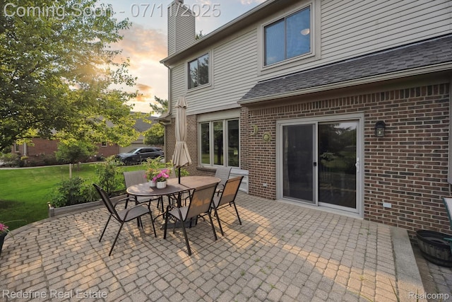 47451 Wallingford Ct, Canton, MI 48188 - patio terrace at dusk featuring a patio, outdoor dining area, and a lawn