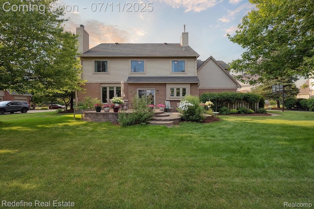 47451 Wallingford Ct, Canton, MI 48188 - back of house with a lawn, brick siding, and a chimney