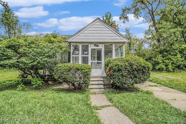 13576 Warwick St, Detroit, MI 48223 - view of front of property with a chimney and a sunroom