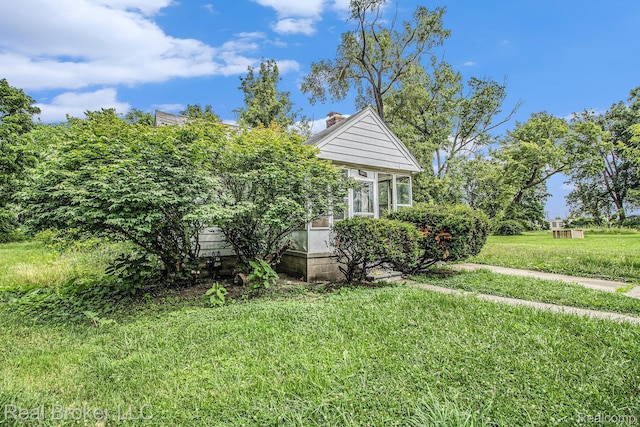 13576 Warwick St, Detroit, MI 48223 - view of home's exterior featuring a lawn and a chimney