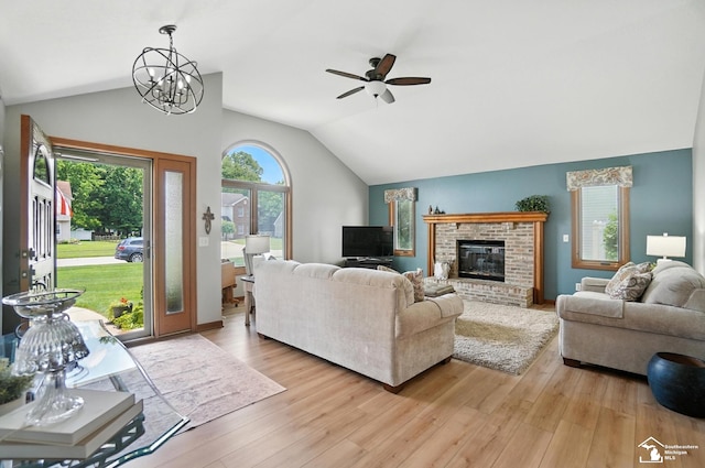 7369 Apple Grove Ln, Temperance, MI 48182 - living room with lofted ceiling, ceiling fan, light wood finished floors, and a fireplace