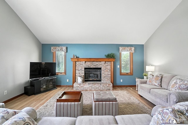 7369 Apple Grove Ln, Temperance, MI 48182 - living area featuring vaulted ceiling, wood finished floors, and a fireplace