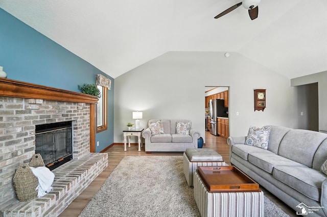 7369 Apple Grove Ln, Temperance, MI 48182 - living area featuring a ceiling fan, wood finished floors, vaulted ceiling, and a fireplace