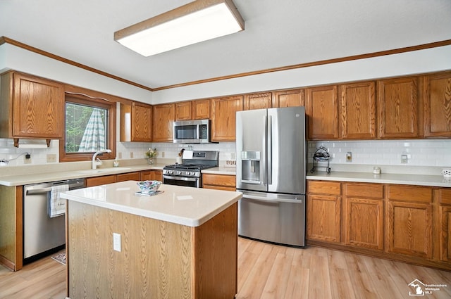 7369 Apple Grove Ln, Temperance, MI 48182 - kitchen with stainless steel appliances, brown cabinetry, backsplash, light countertops, and crown molding