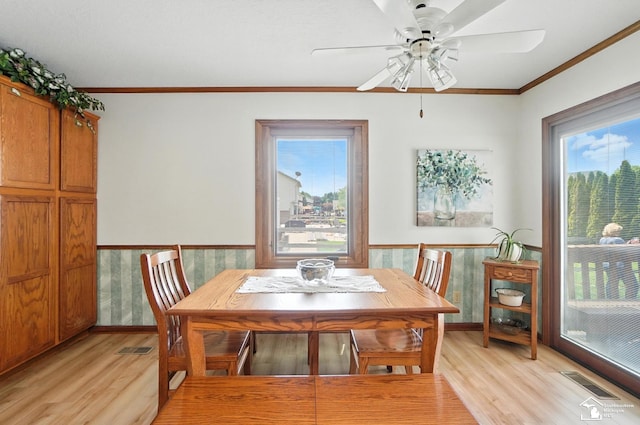 7369 Apple Grove Ln, Temperance, MI 48182 - dining space with light wood finished floors, crown molding, wainscoting, and a ceiling fan