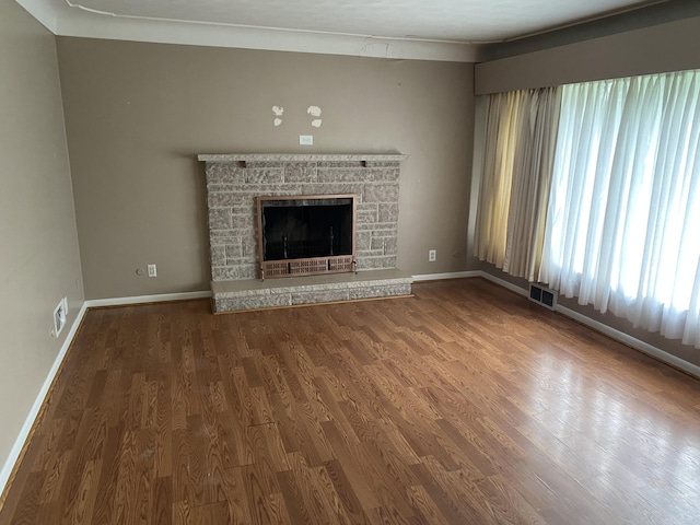 6832 Oakland Dr, Portage, MI 49024 - unfurnished living room with plenty of natural light, wood finished floors, and a stone fireplace