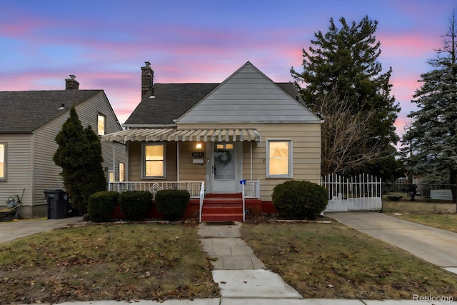 18291 Henry St, Melvindale, MI 48122 - bungalow-style home with a porch and roof with shingles