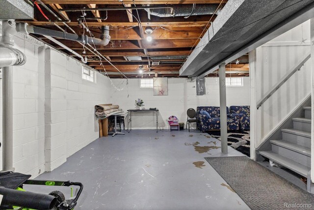 18291 Henry St, Melvindale, MI 48122 - basement featuring stairs, concrete block wall, and electric panel