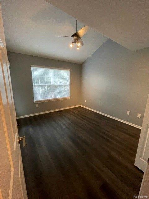 1530 Maryland Club Dr, Royal Oak, MI 48067 - spare room featuring a ceiling fan, dark wood-type flooring, and lofted ceiling