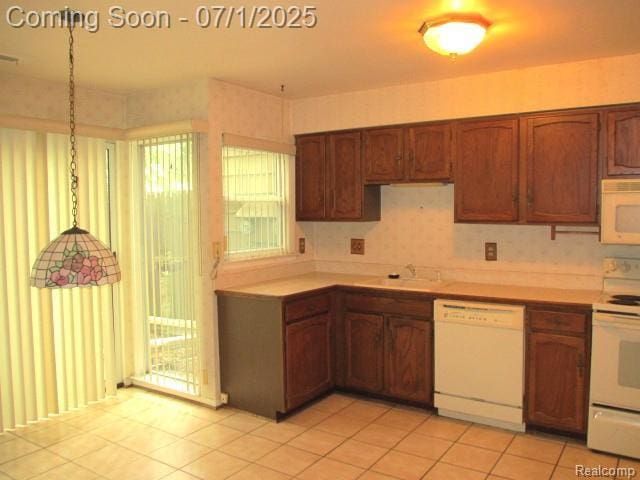 2667 Williamsburg Cir, Auburn Hills, MI 48326 - kitchen with white appliances, light countertops, light tile patterned floors, and brown cabinetry