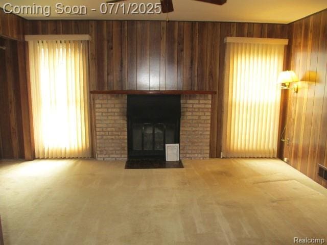 2667 Williamsburg Cir, Auburn Hills, MI 48326 - unfurnished living room with carpet floors, a ceiling fan, wooden walls, and a fireplace