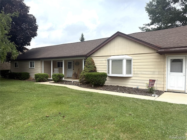 25830 Matilda Ave, Trenton, MI 48134 - ranch-style home with a porch, a front lawn, roof with shingles, and board and batten siding