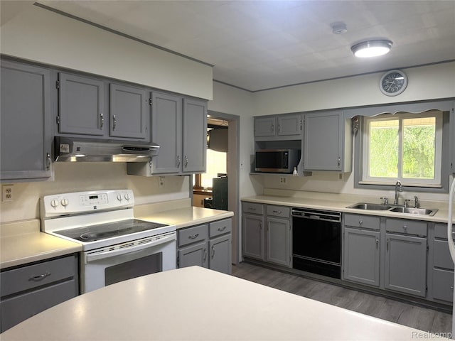25830 Matilda Ave, Trenton, MI 48134 - kitchen with white electric range oven, black dishwasher, under cabinet range hood, and gray cabinets