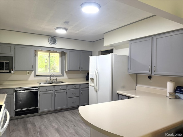 25830 Matilda Ave, Trenton, MI 48134 - kitchen with black dishwasher, gray cabinets, white refrigerator with ice dispenser, light countertops, and a peninsula