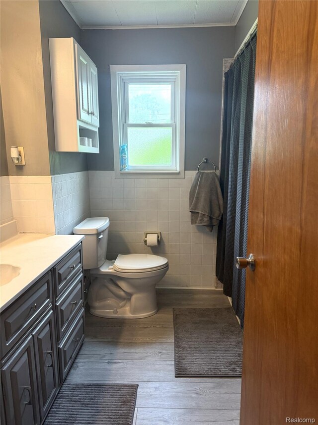 25830 Matilda Ave, Trenton, MI 48134 - full bathroom featuring tile walls, wood finished floors, ornamental molding, vanity, and a wainscoted wall