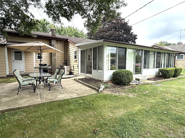 25830 Matilda Ave, Trenton, MI 48134 - back of house with a sunroom, a patio area, a chimney, a lawn, and roof with shingles