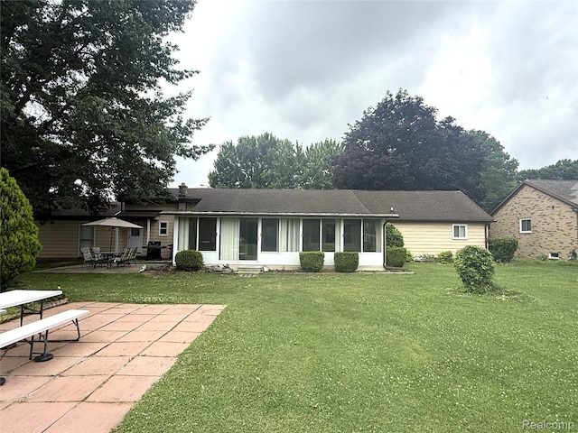 25830 Matilda Ave, Trenton, MI 48134 - back of property featuring a sunroom, a patio area, and a lawn