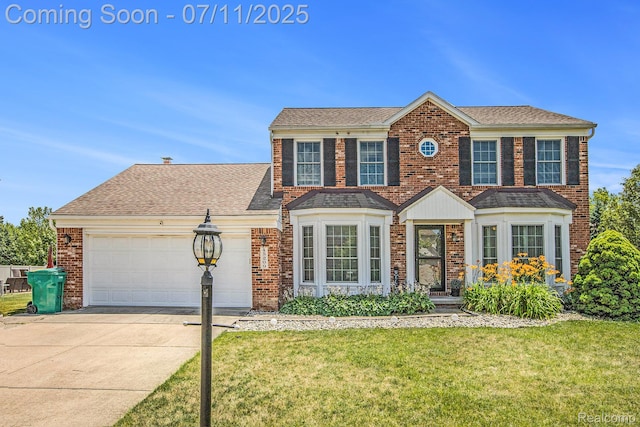 45209 Greenbriar Dr, Van Buren, MI 48111 - view of front of property with a garage, a front lawn, brick siding, and concrete driveway