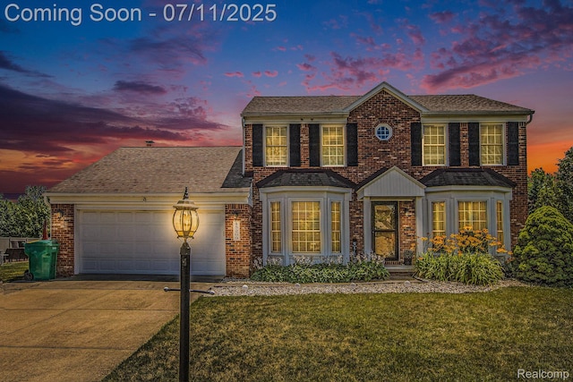 45209 Greenbriar Dr, Van Buren, MI 48111 - colonial-style house featuring an attached garage, driveway, a front lawn, and brick siding