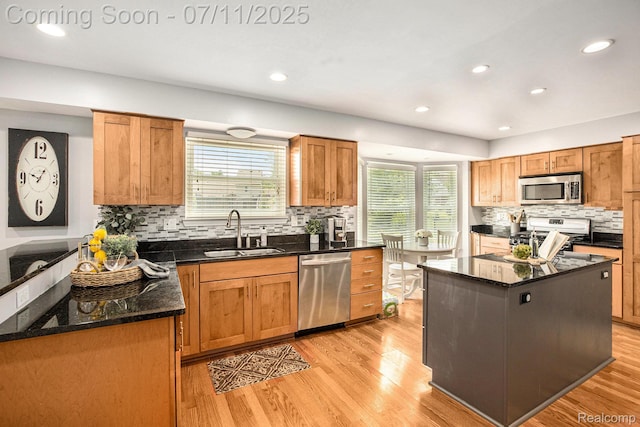 45209 Greenbriar Dr, Van Buren, MI 48111 - kitchen with stainless steel appliances, plenty of natural light, backsplash, light wood-style floors, and recessed lighting