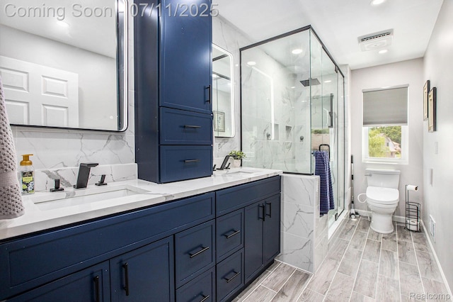 45209 Greenbriar Dr, Van Buren, MI 48111 - bathroom with double vanity, a marble finish shower, and recessed lighting