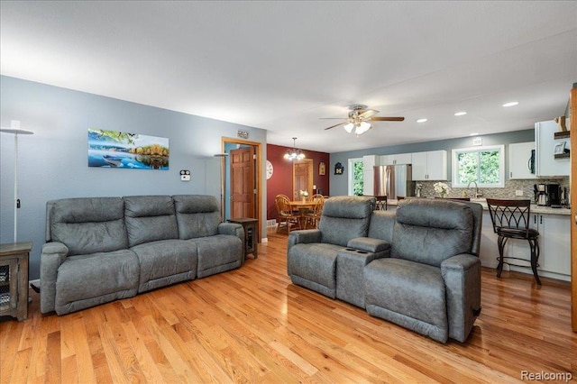 14165 Crampton Rd, Camden, MI 49232 - living room with light wood-style flooring, a ceiling fan, recessed lighting, and a chandelier